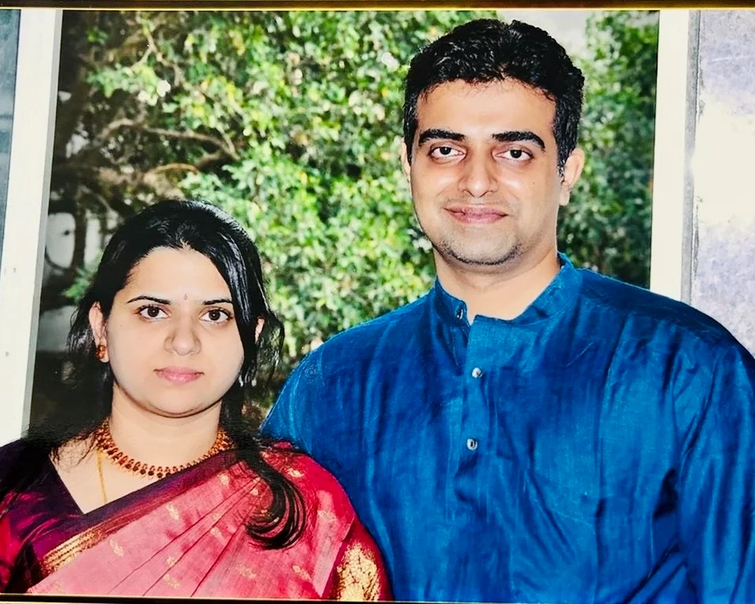 An early portrait of Bhargav and his wife in traditional silk, taken in a garden